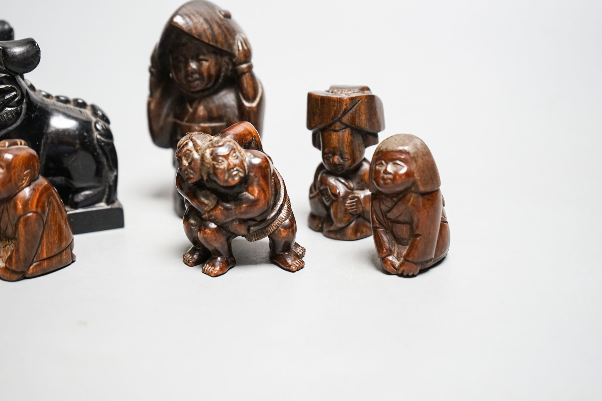 A quantity of hardwood netsuke and other carvings, signed
